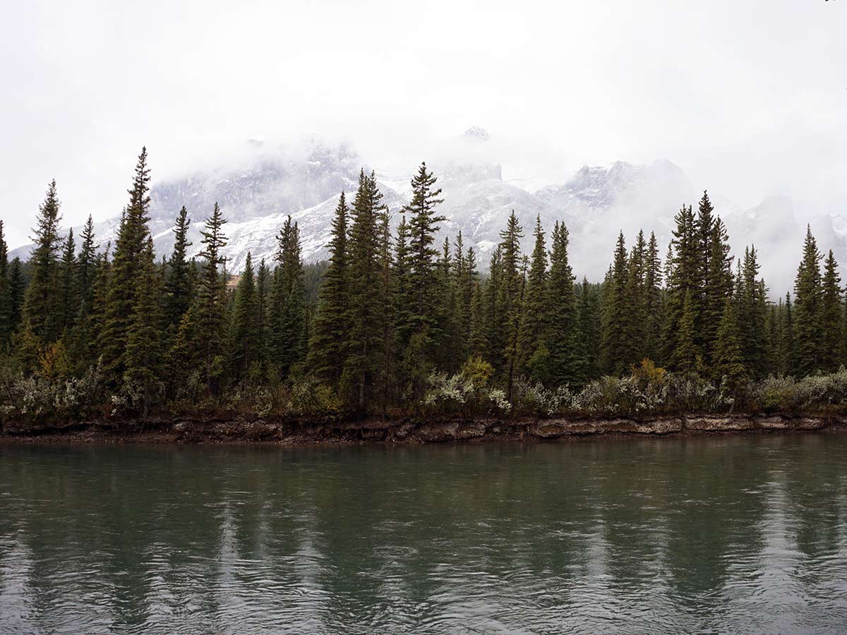 The mountains over the Bow River on the Main Street, Bow River and the Rail Bridge Hike in Canmore, Alberta