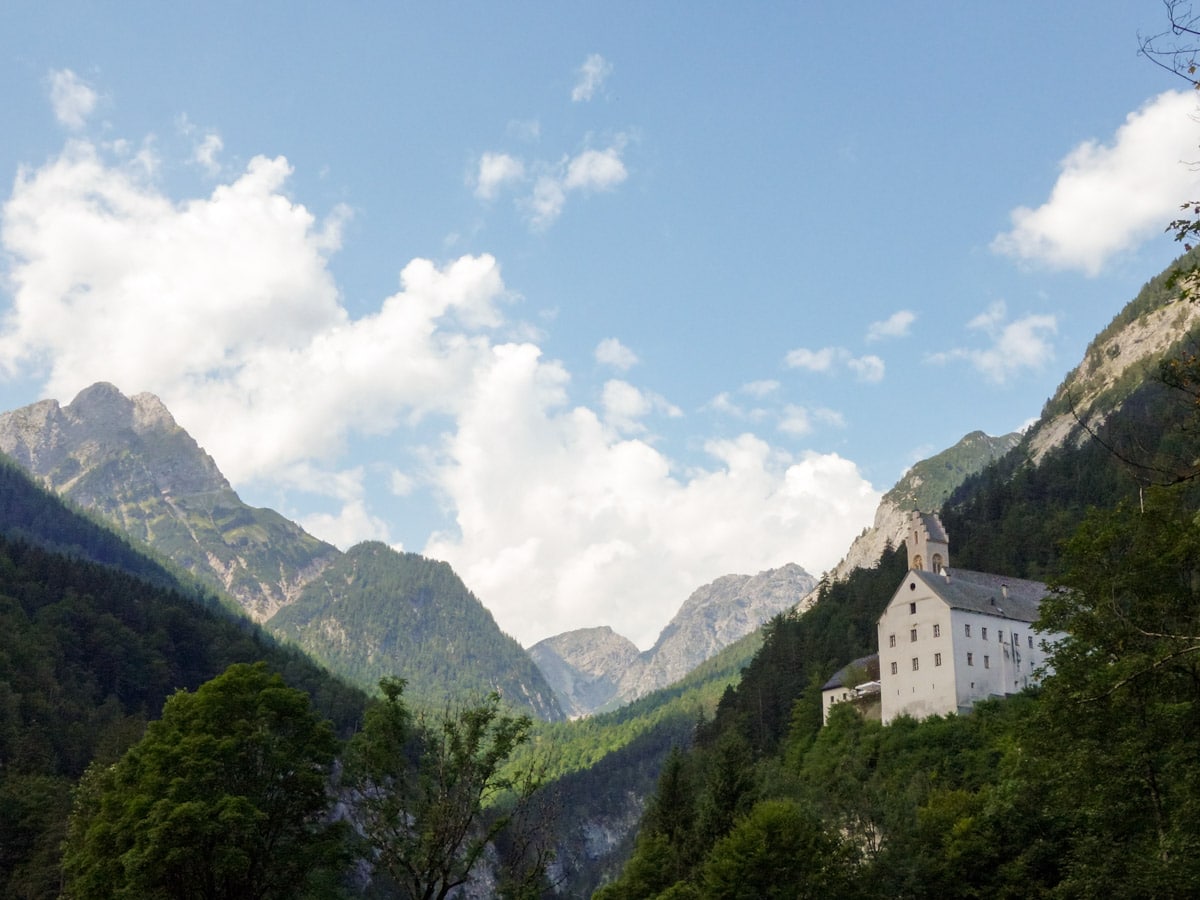 The monastery as seen from the forest on the Wolfsklamm Hike in Innsbruck, Austria