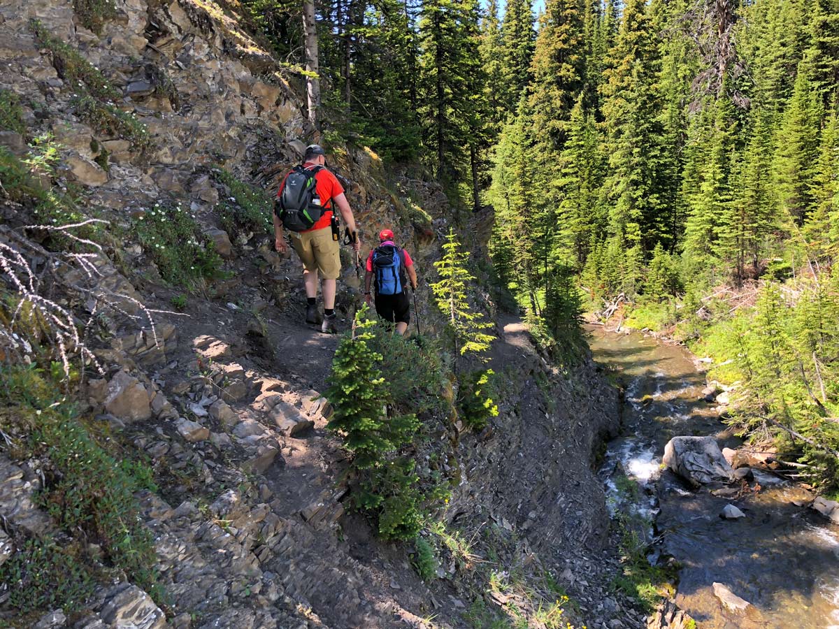 Hikers on the tricky part of ascent by falls on the Rummel Pass Hike near Smith-Dorrien Trail in Kananaskis, near Canmore