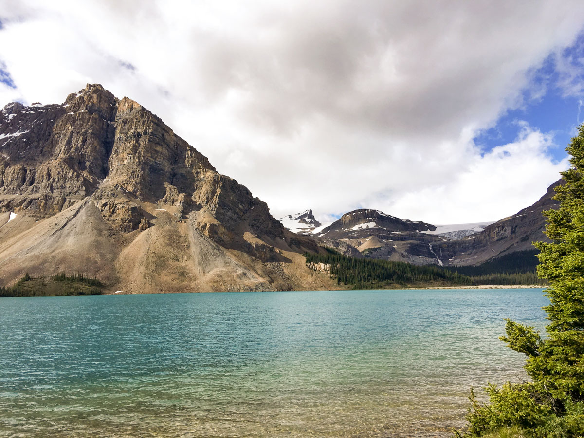 Walking along the lake on Bow Lake hike from Icefields Parkway, Alberta, Canada