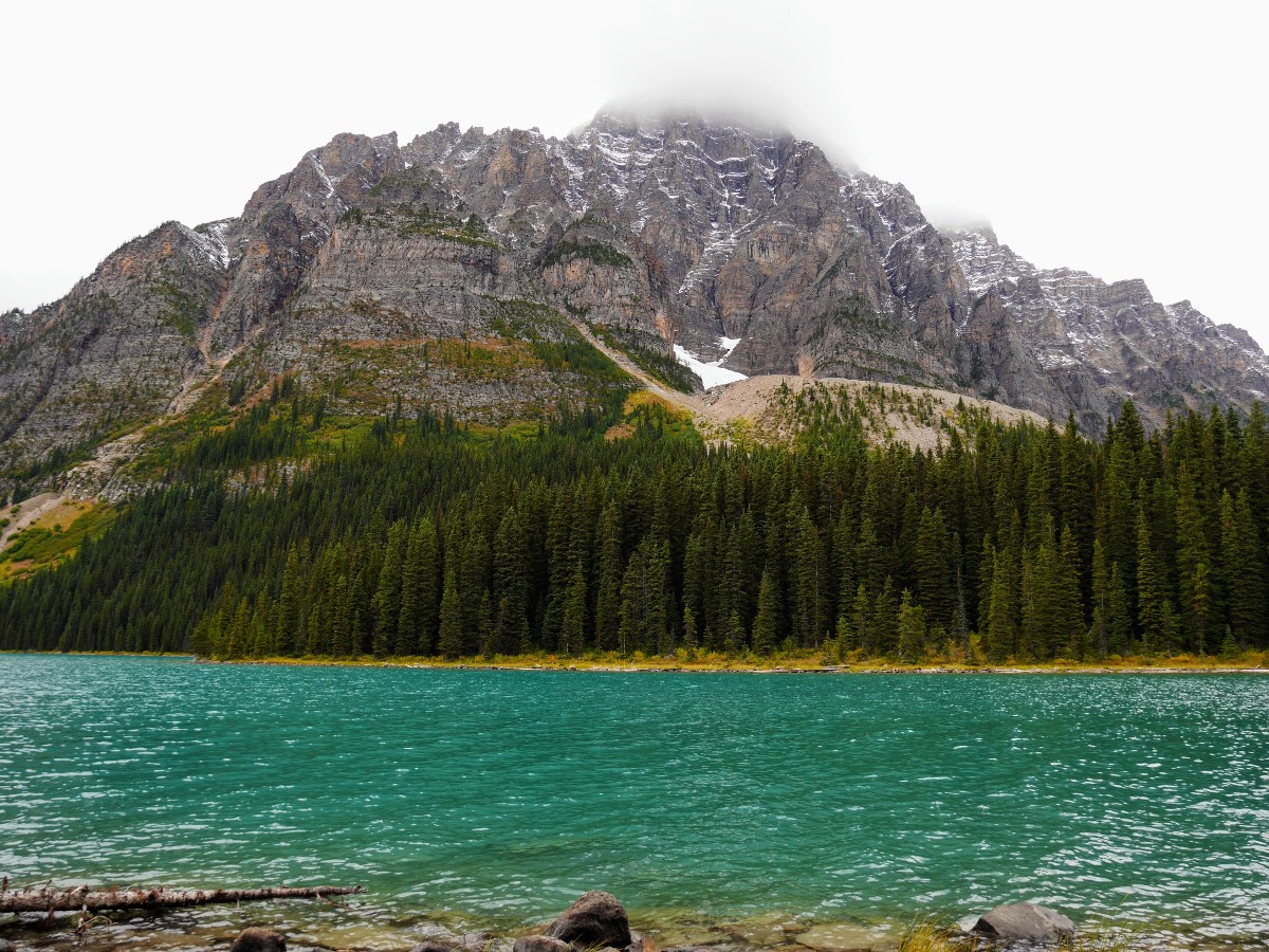 Mt Cephran's peak in the cloud above the lake on the Cirque & Chephren Lakes Hike from the Icefields Parkway near Banff National Park