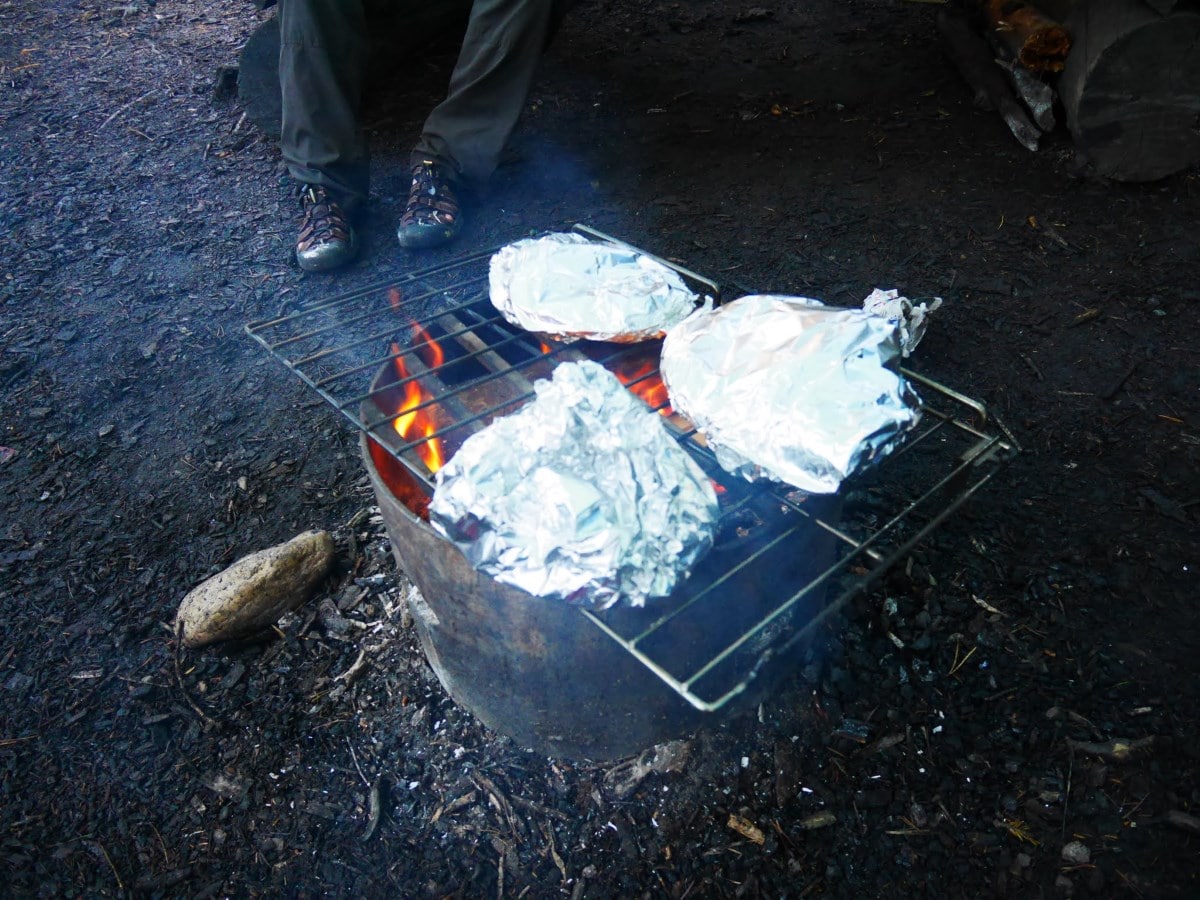 Tips for backcountry cooking include cooking pizza on the fire pit!
