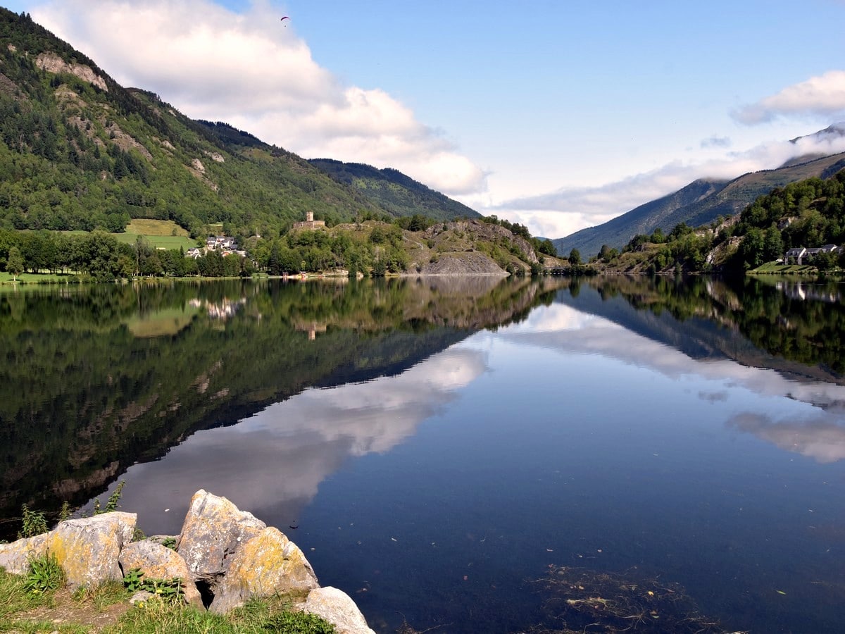 View over the lake and the castle on the Lac de Loudenvielle Hike in French Pyrenees