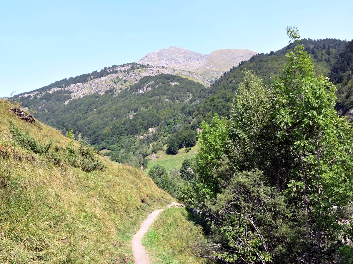 Small path along the bank on the Cirque de Gavarnie Hike in French Pyrenees