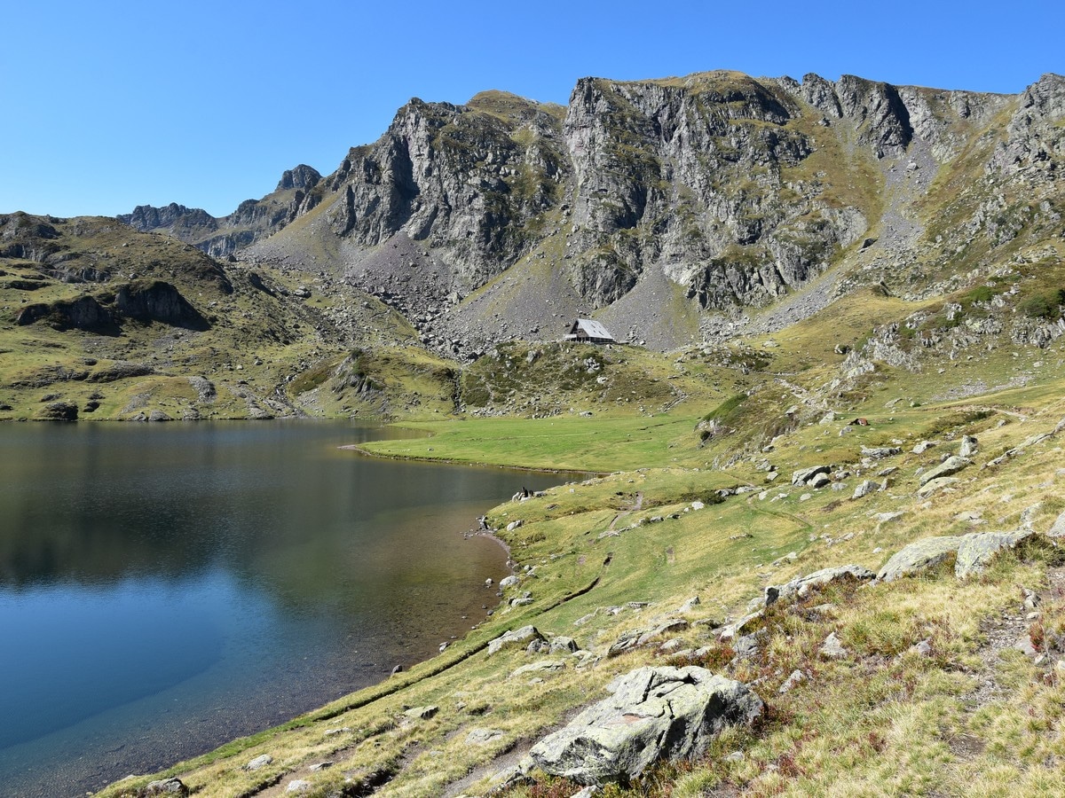Lac Gentau and the Refuge d'Ayous at the foot of the cliffs on the Lacs et Pic d'Ayous Hike in French Pyrenees