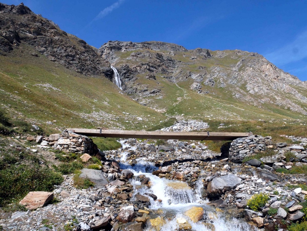 Crossing the waterfall on the Vallon du Prariond Hike in Vanoise National Park in France