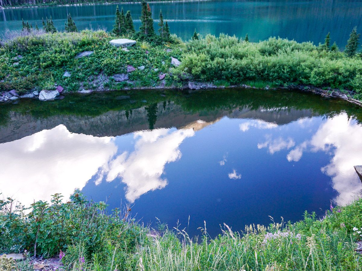 Reflections on the lake at Grinnell Glacier Hike in Glacier National Park