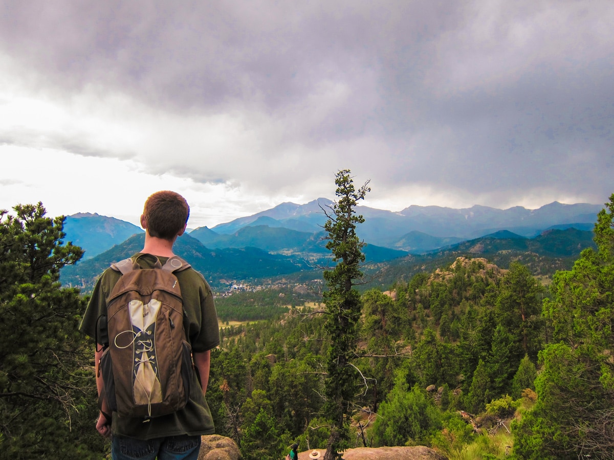 Hiker on a trail of Gem Lake and Balanced Rock hike in Rocky Mountain National Park, Colorado