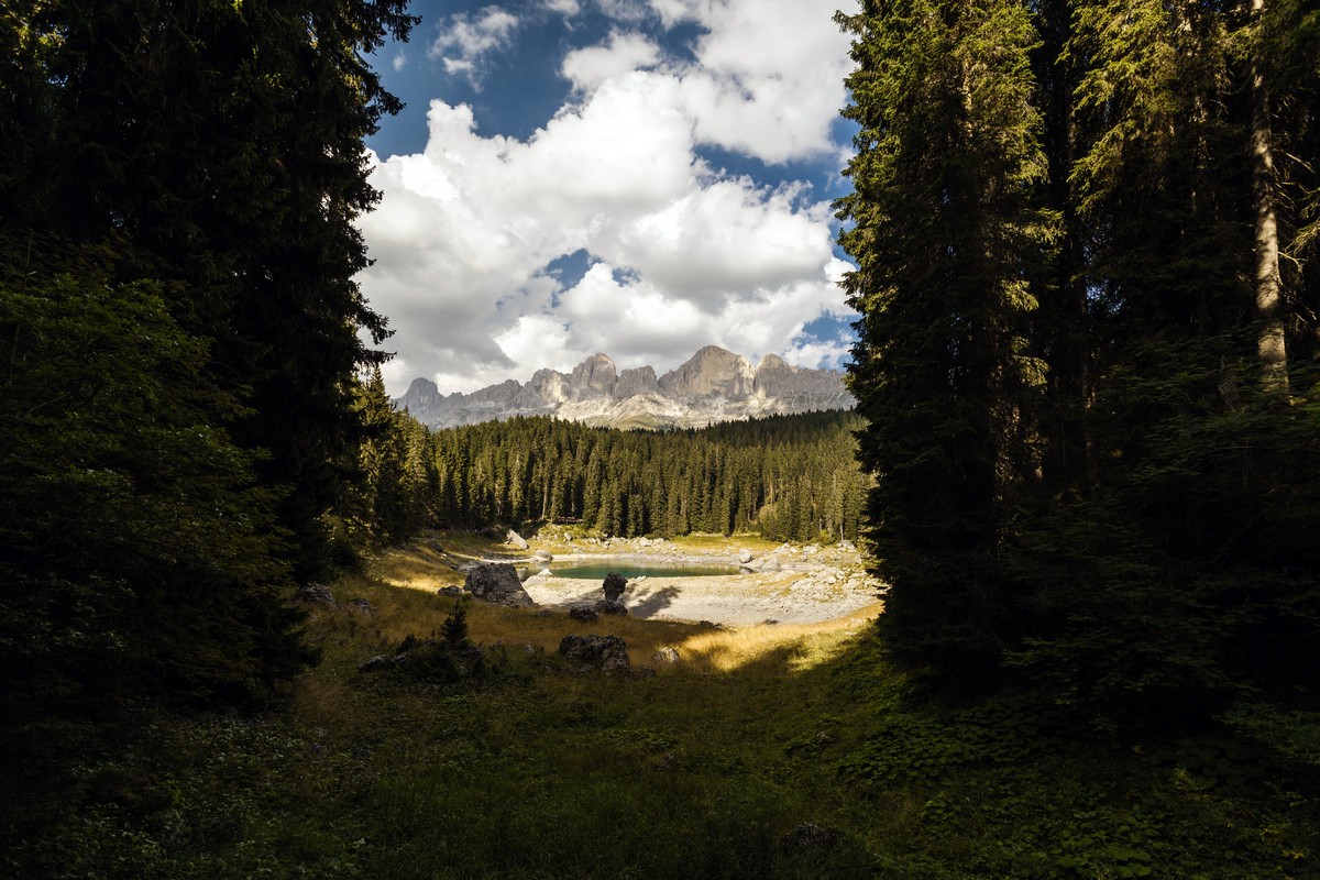 The lake and the Catinaccio mountains on the Lago di Carezza Hike in Dolomites, Italy