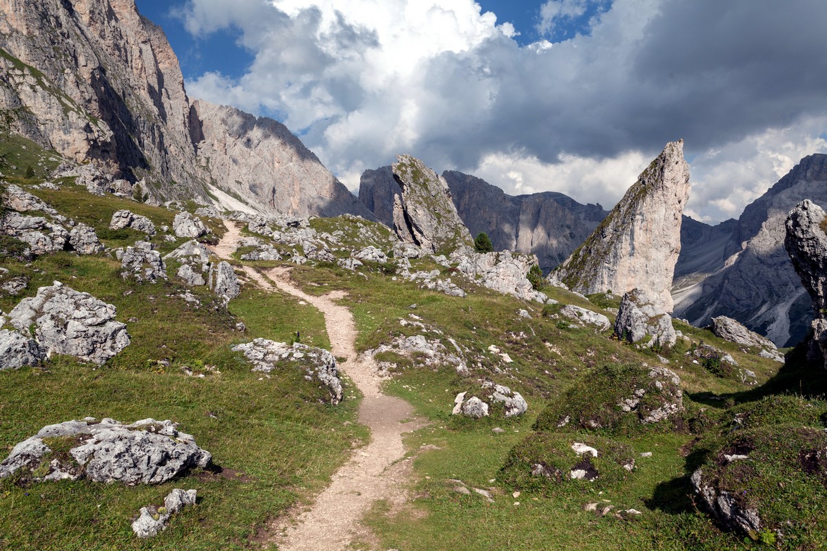 Path at the side of the mountains among rocks on the Seceda / Puez Odle Hike in Dolomites, Italy
