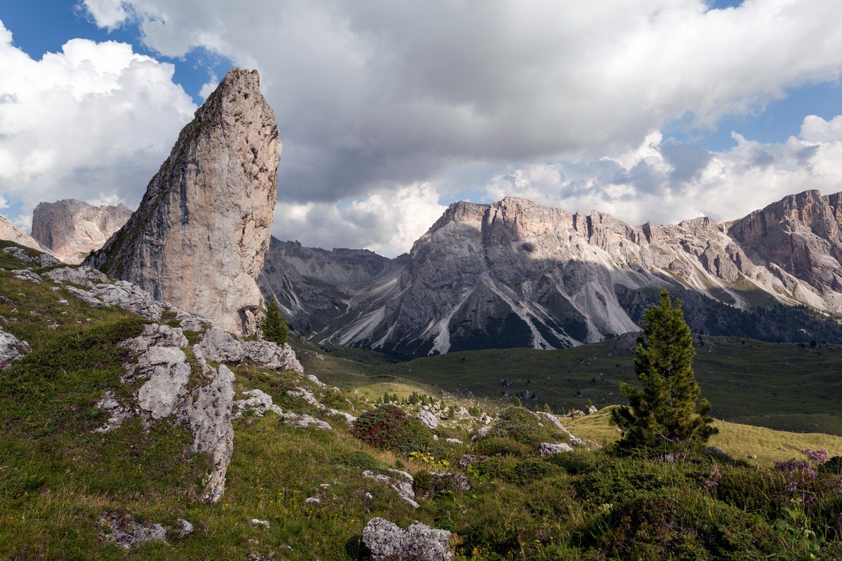 Characteristic rock formation with the Puez mountains on the background as seen from the Seceda / Puez Odle Hike in Dolomites, Italy
