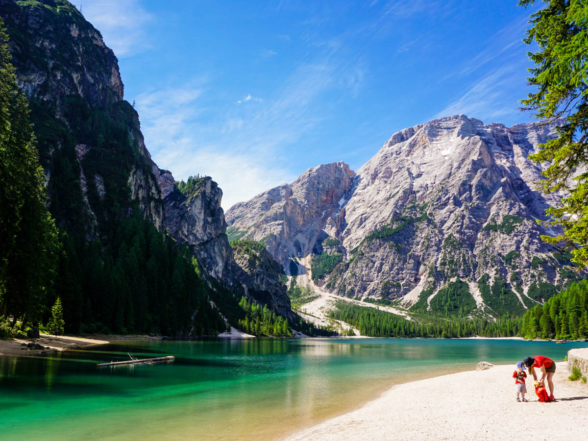 On the beach at the family friendly trail of the Lago di Braies Hike in Dolomites, Italy