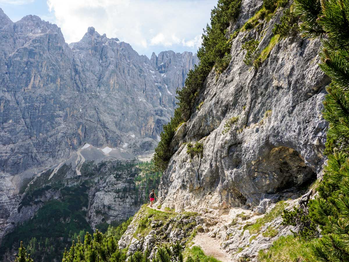 Narrow pathway with chains on the Lago di Sorapiss Hike in Dolomites, Italy