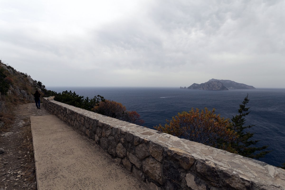 The ancient Roman cobblestones and Capri from the Punta Campanella Hike in Amalfi Coast, Italy
