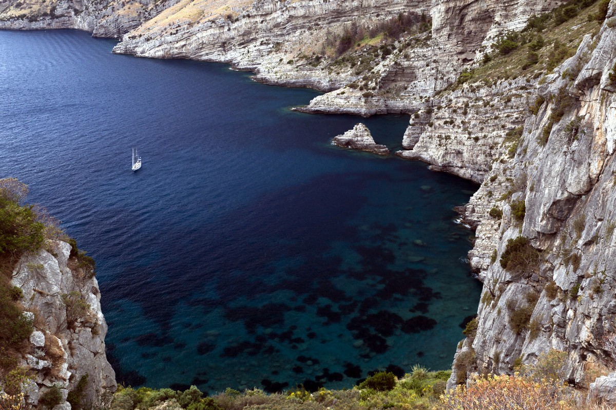 Boat in the bay from the Bay of Ieranto Hike in Amalfi Coast, Italy