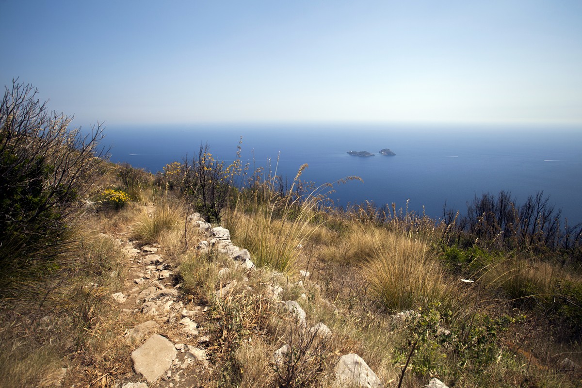 The trail and Li Galli archipelago from the Monte Comune Hike in Amalfi Coast, Italy