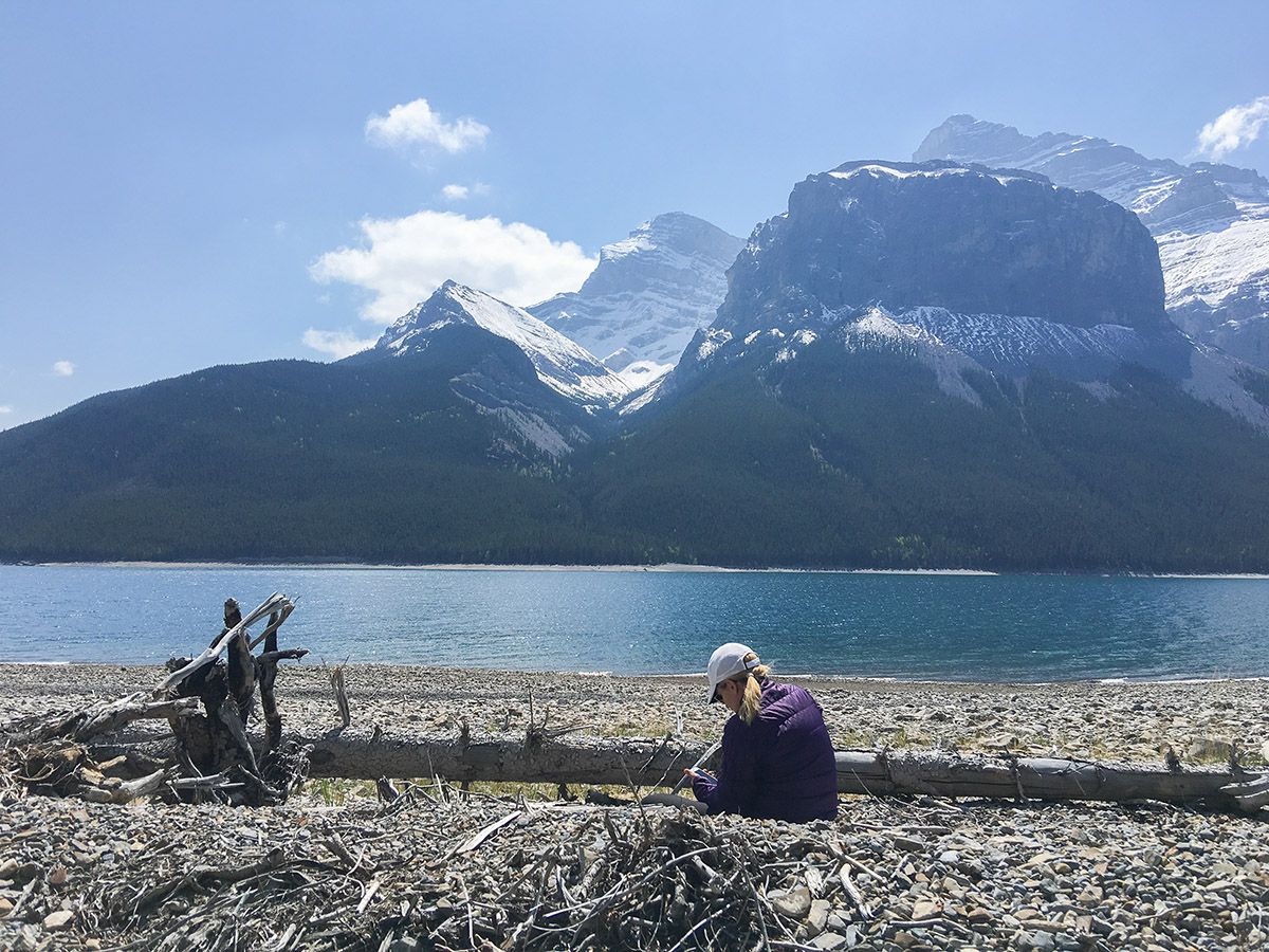 Lady sitting near the lake on the Aylmer Lookout via Lake Minnewanka Hike near Banff