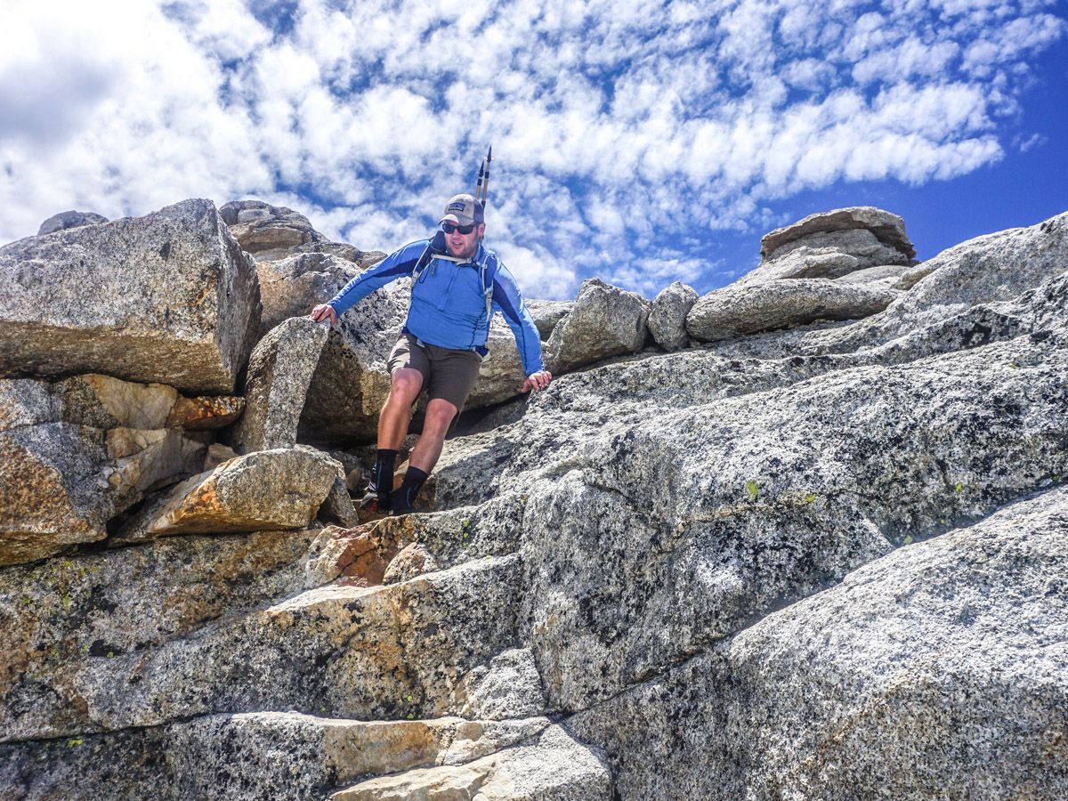 Man climbing on the rocks at Mount Hoffman Hike in Yosemite National Park