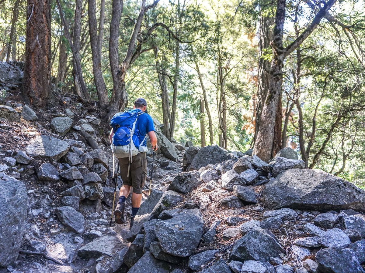 Man hiking over the rocks at Hike Mist Trail in Yosemite National Park