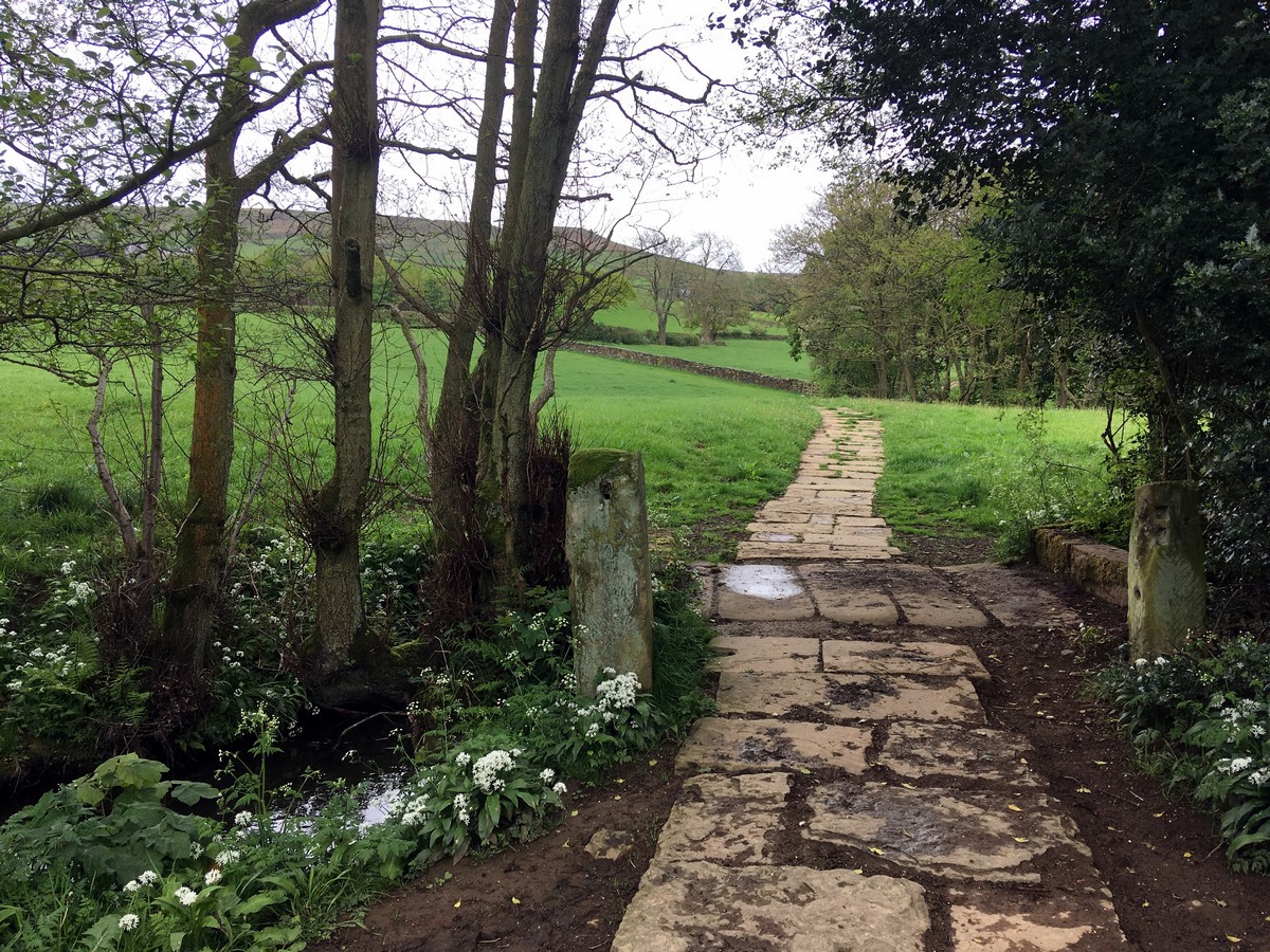 Crossing stream close to Church Houses on the Farndale "Daffodil walk" Hike in North York Moors, England
