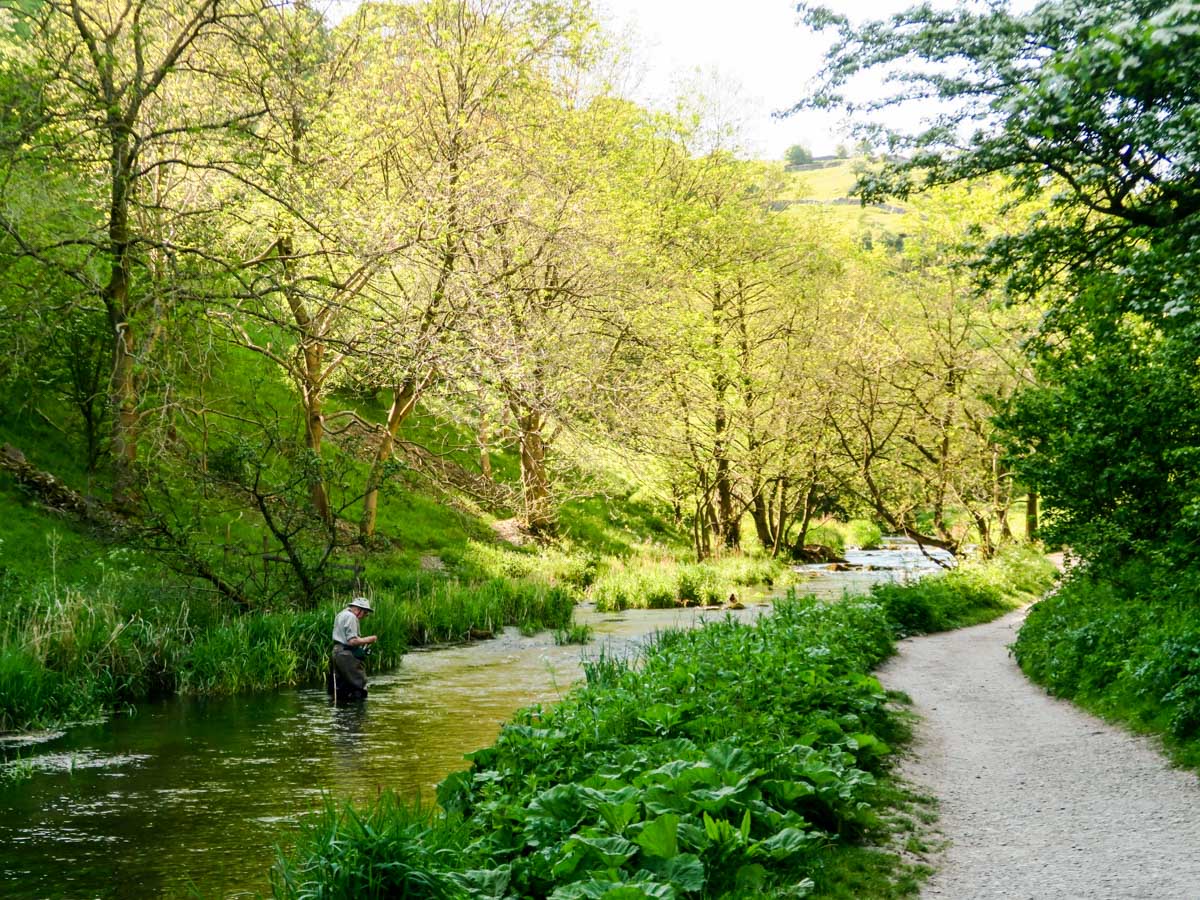 Flyfisher fishing along the Dovedale Circular Hike in Peak District, England