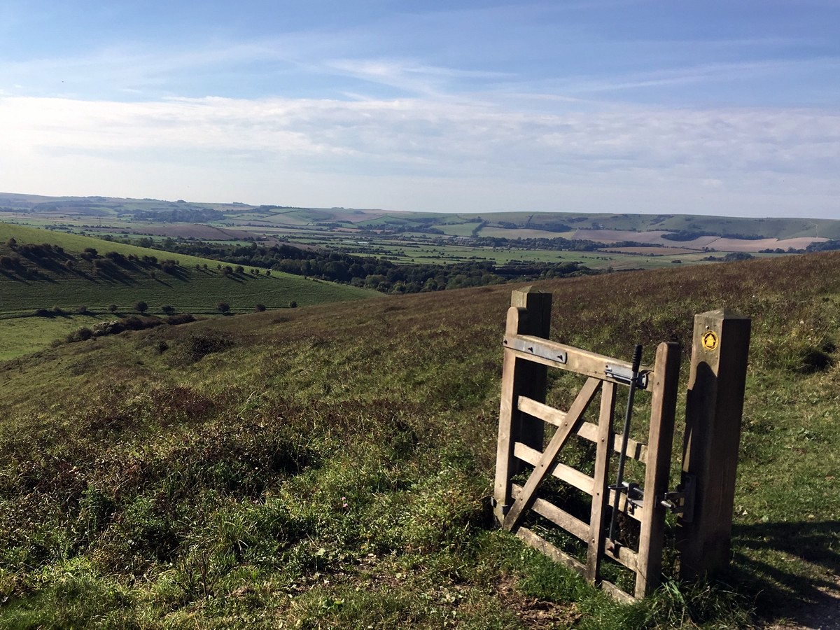 The gate with no fence with views towards Lewes from the Glynde and Mount Caburn Hike in South Downs, England