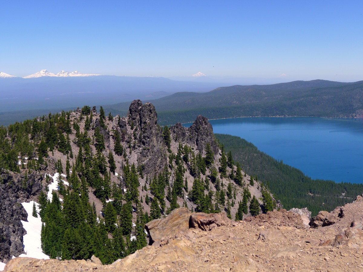 Looking down along summit ridge with sisters in the background on the Paulina Peak Hike near Bend, Oregon