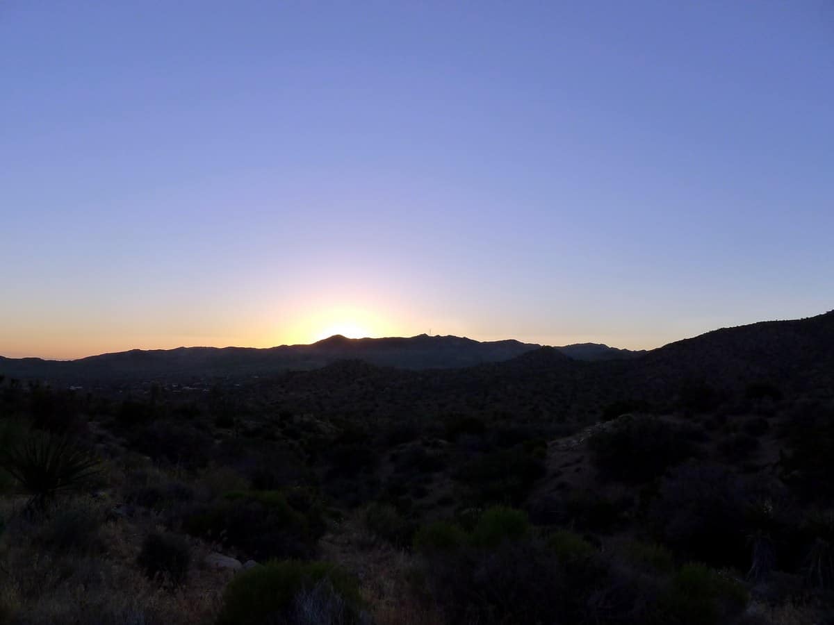 Sunrise over the mountains from the Warren Peak Hike in Joshua Tree National Park, California