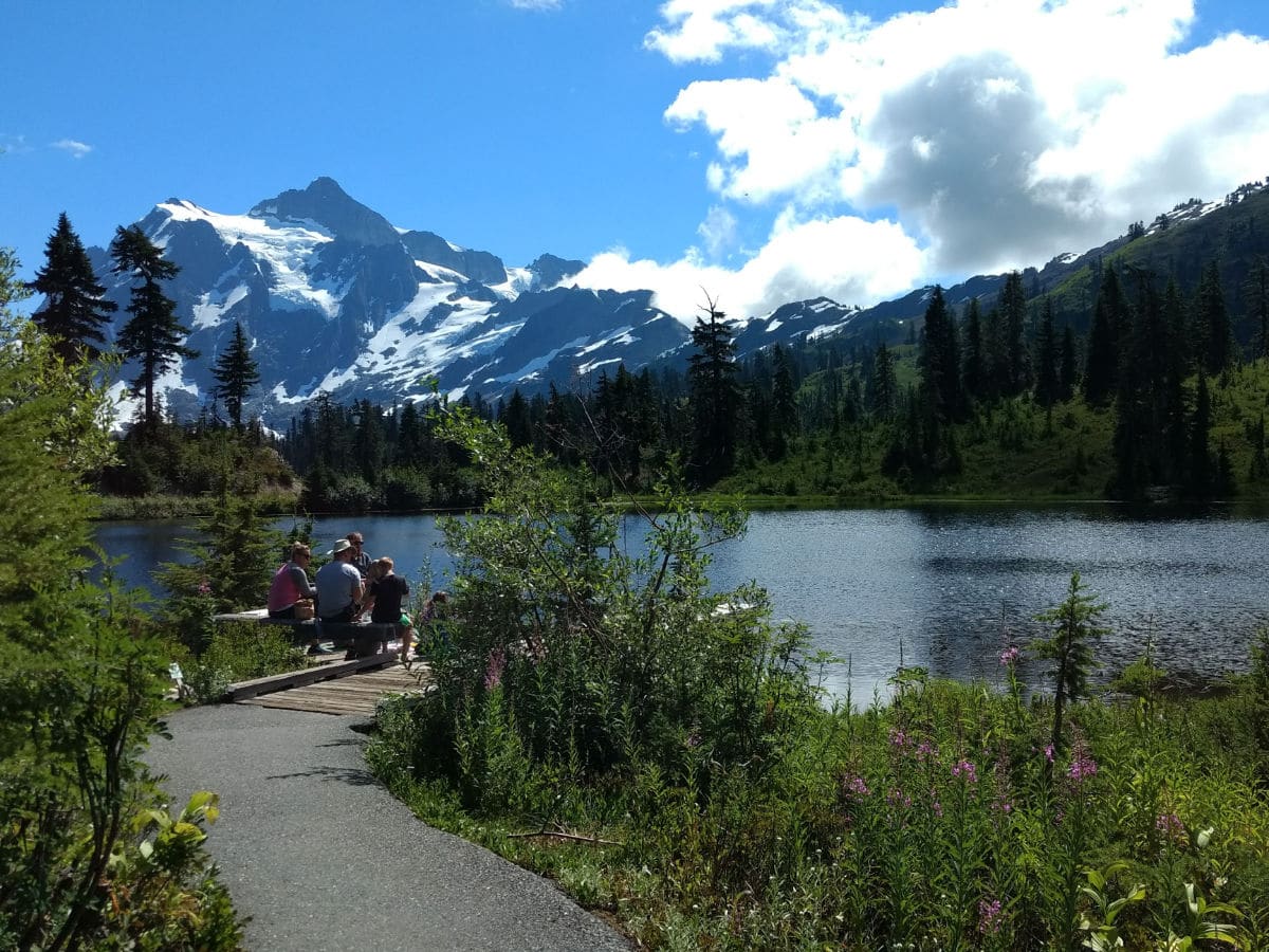 A family by the lake on the Picture Lake Hike near Mt Baker, Washington