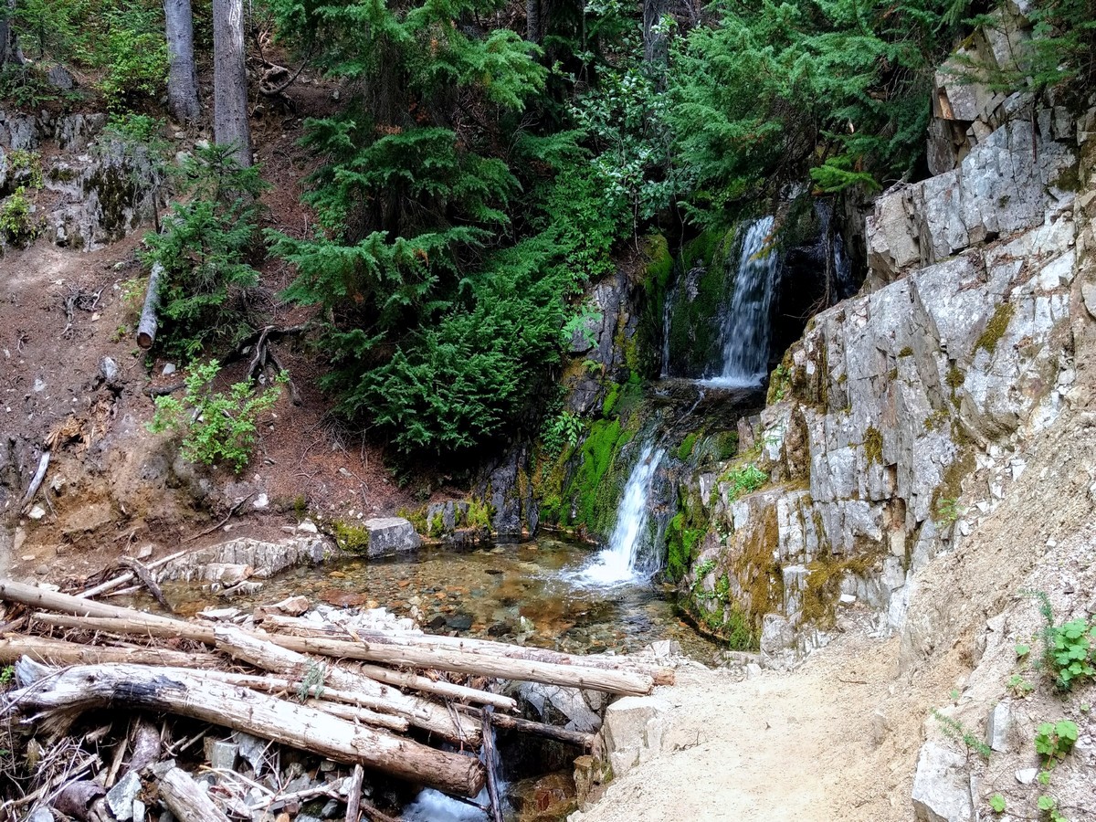 A small waterfall over the trail on the Cutthroat Pass Hike in North Cascades National Park, Washington