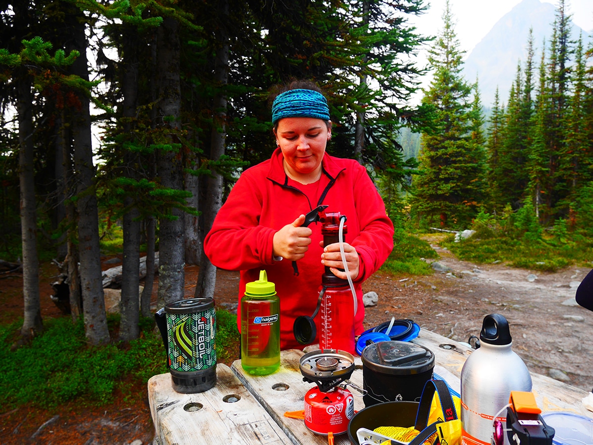 Using a water filter on a hike