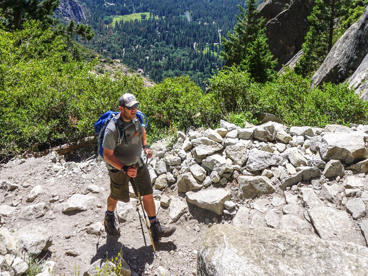 Man with gear hiking in Yosemite Falls Hike Yosemite National Park