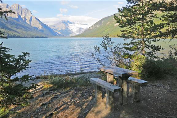 Bench near the lake on Glacier Lake Backpacking trail in Banff National Park