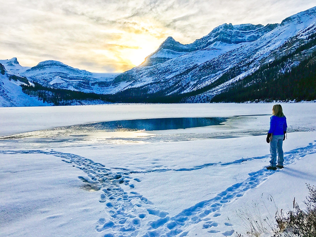 Almost frozen lake on Bow Lake snowshoe trail in Banff National Park