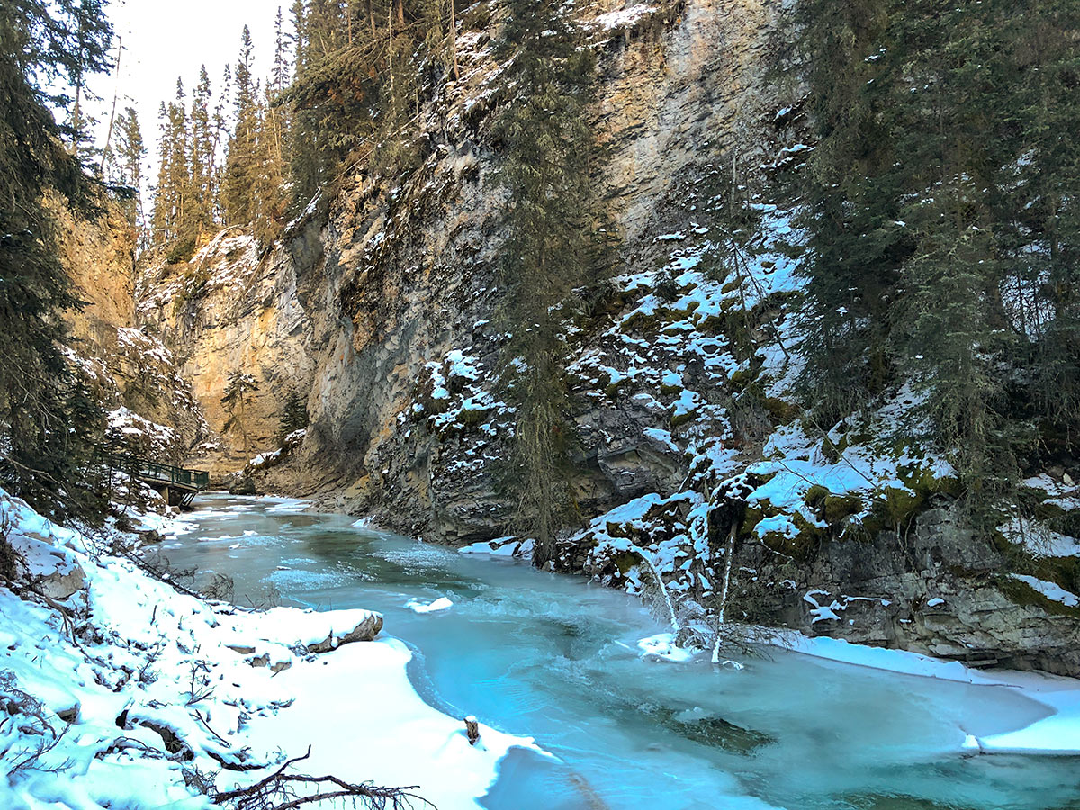 Beautiful color of the water and ice on Johnston Canyon snowshoe trail in Banff National Park