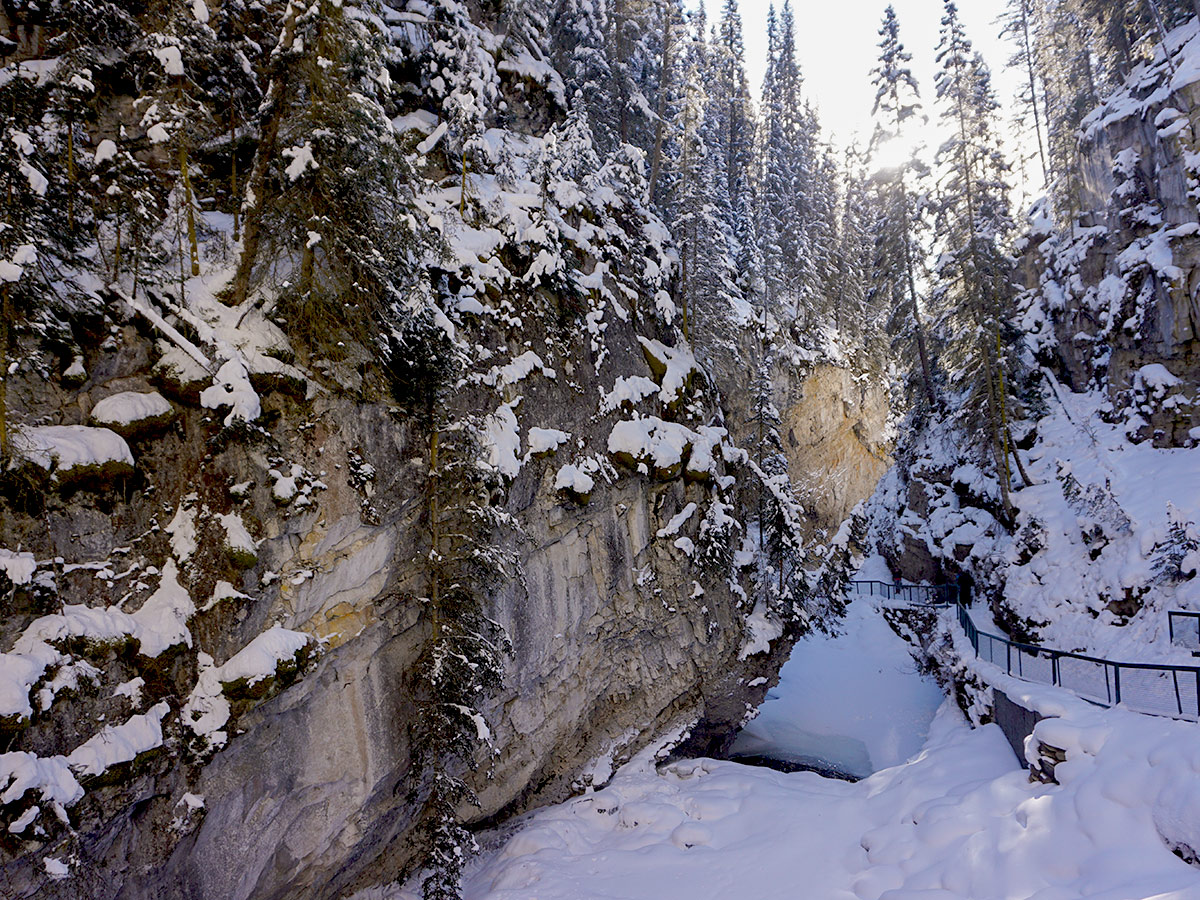 Winter hiking on ice on Johnston Canyon snowshoe trail in Banff National Park