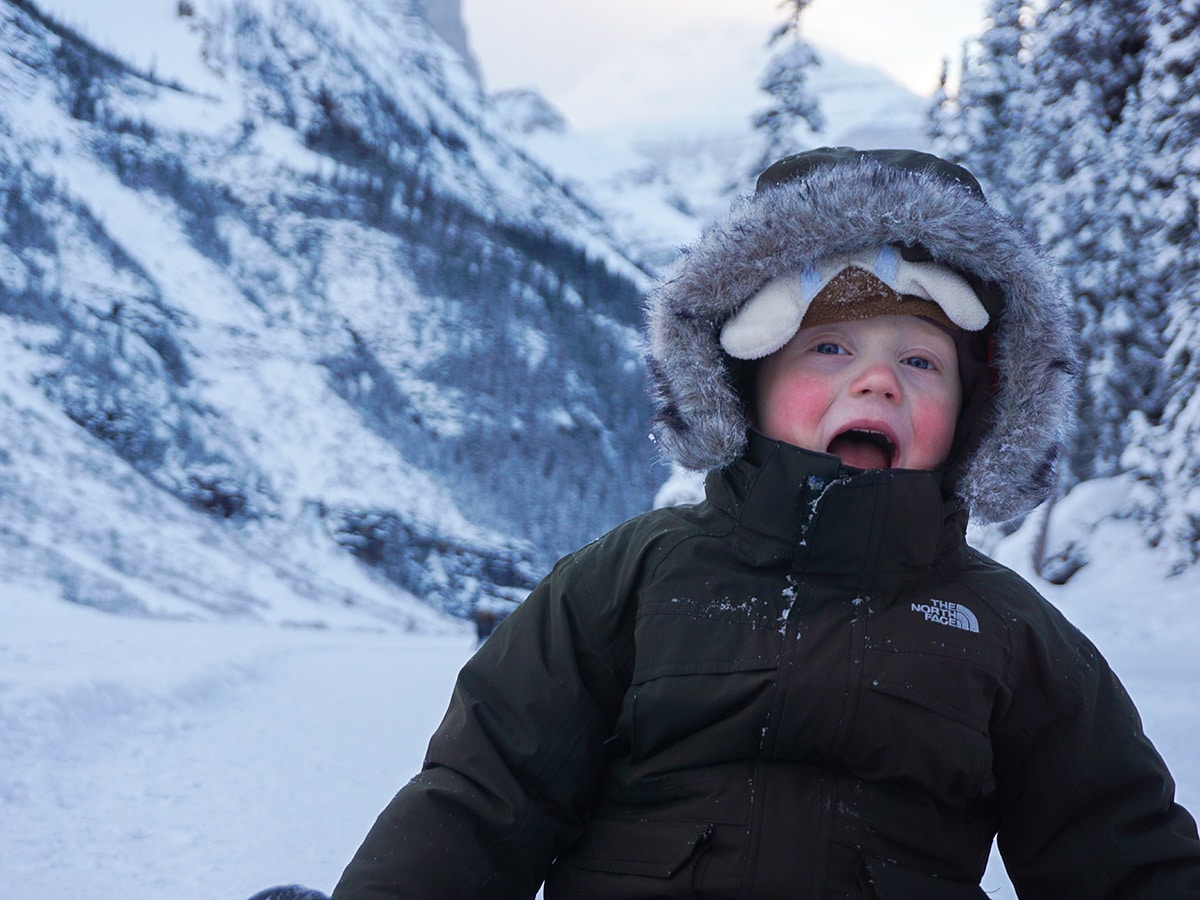 Kids having fun on Lake Louise snowshoe trail in Banff National Park