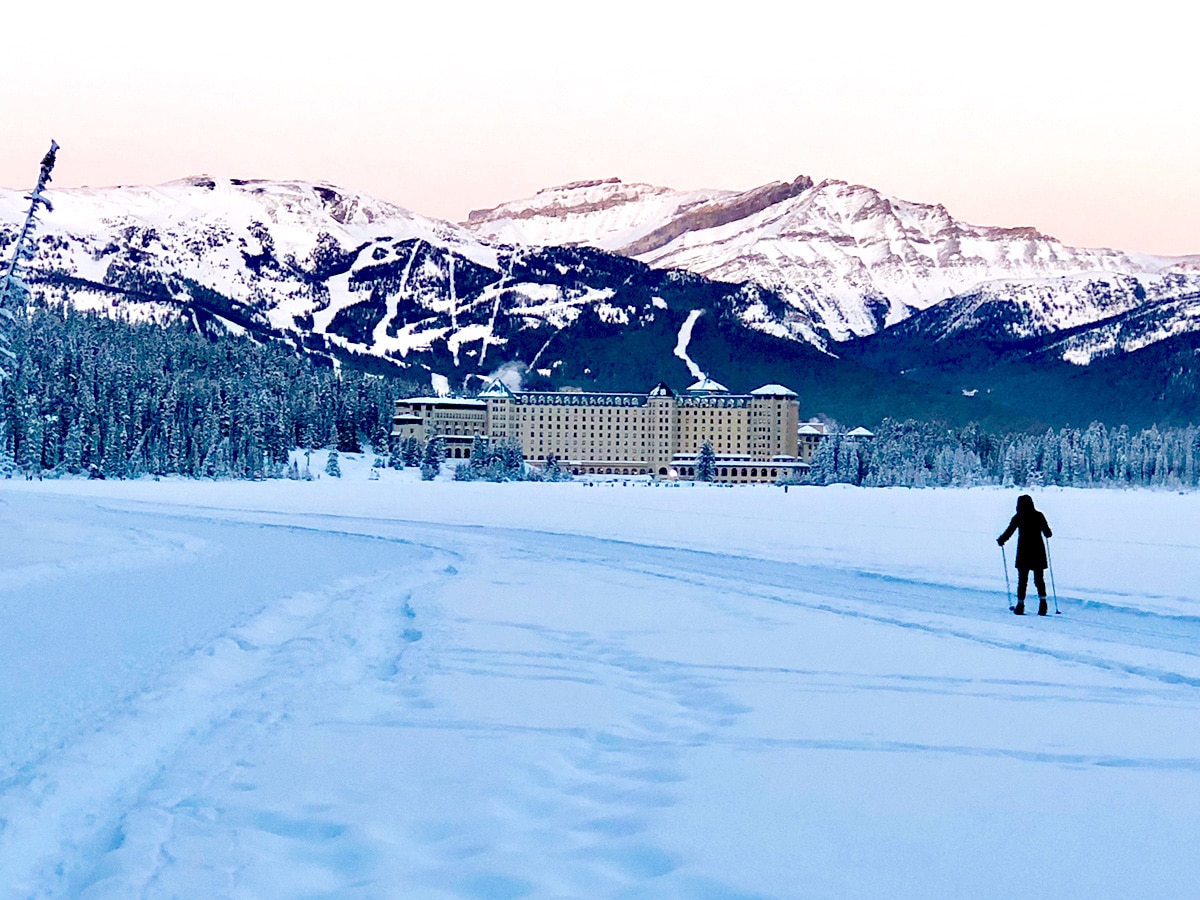 Cross country skier on Lake Louise snowshoe trail in Banff National Park