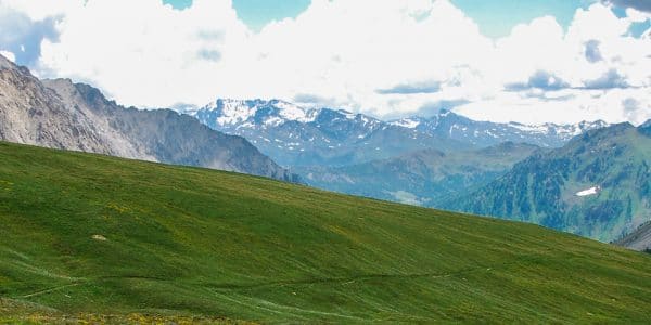 Panoramic view of a man hiking on GR5 hike in Alps