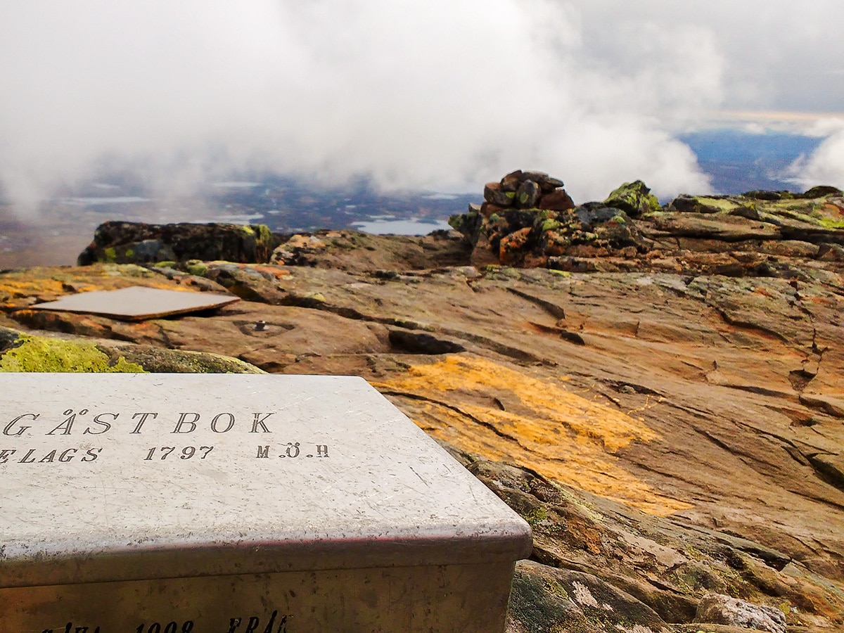 Writing in the guest book on Helagstoppen hike in Åre, Sweden