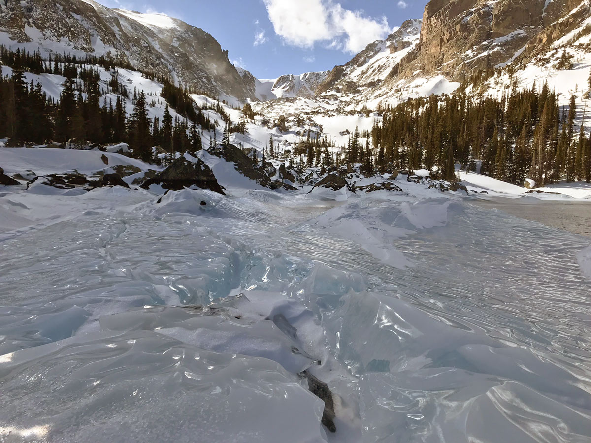 Lake Haiyaha snowshoe trail in Rocky Mountain National Park goes on frozen lake