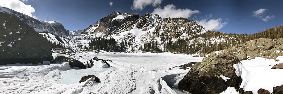 Frozen lake on Lake Haiyaha snowshoe trail in Rocky Mountain National Park, Colorado