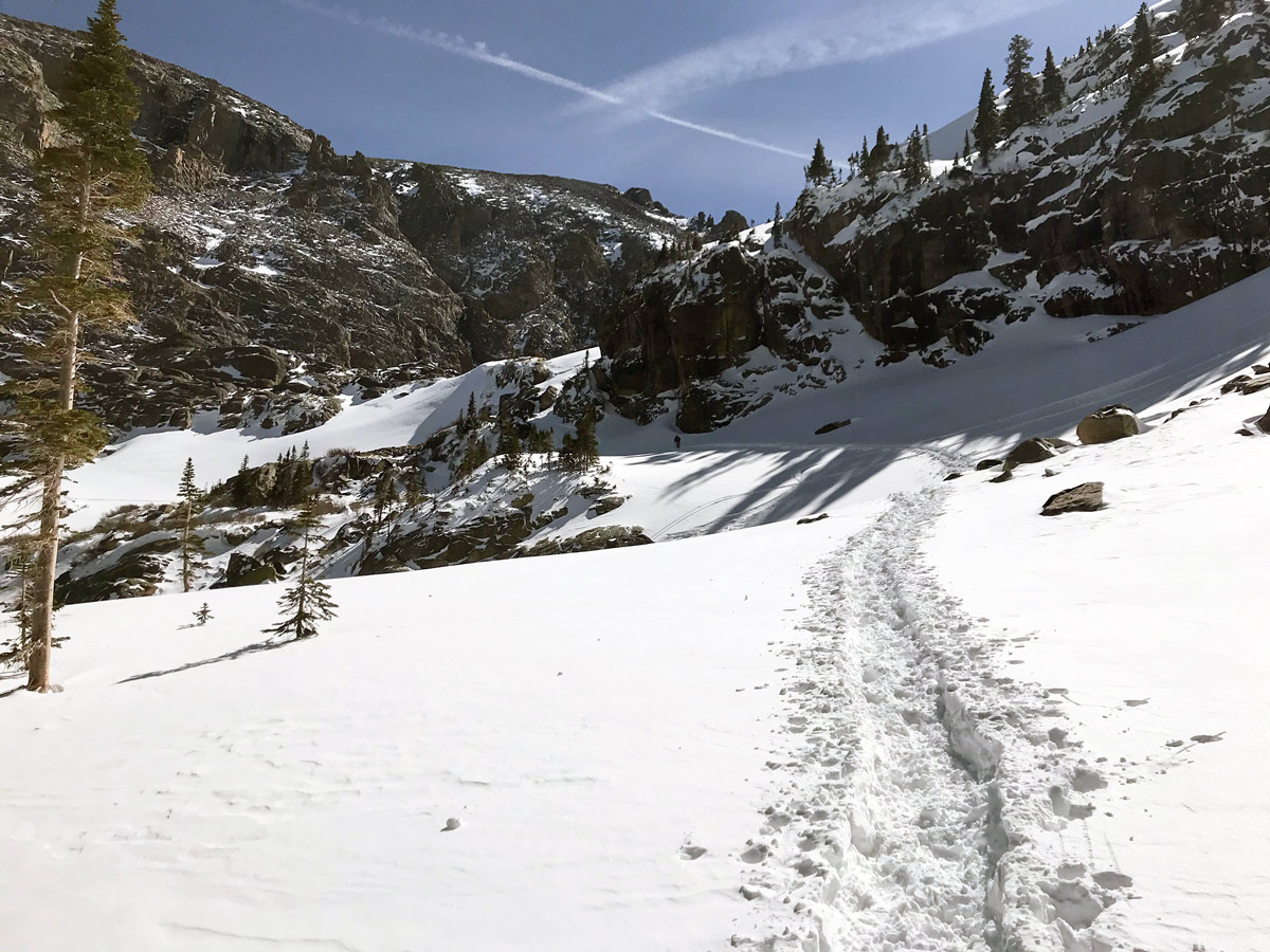 Hiking upon Sky Pond snowshoe trail in Rocky Mountain National Park, Colorado