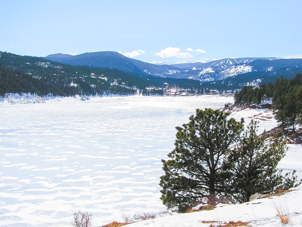 Frozen lake on Barker Reservoir snowshoe trail in Indian Peaks, Colorado