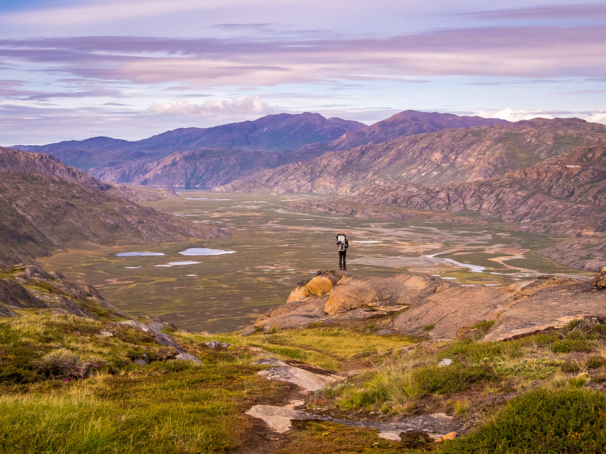 Hiker and valley views on Arctic Circle Trail hike