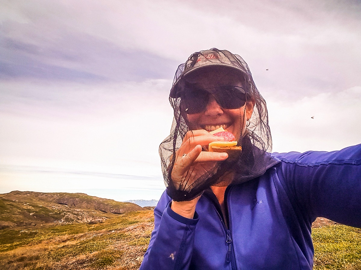 Challenging eating with a head net on Greenland’s Arctic circle trail