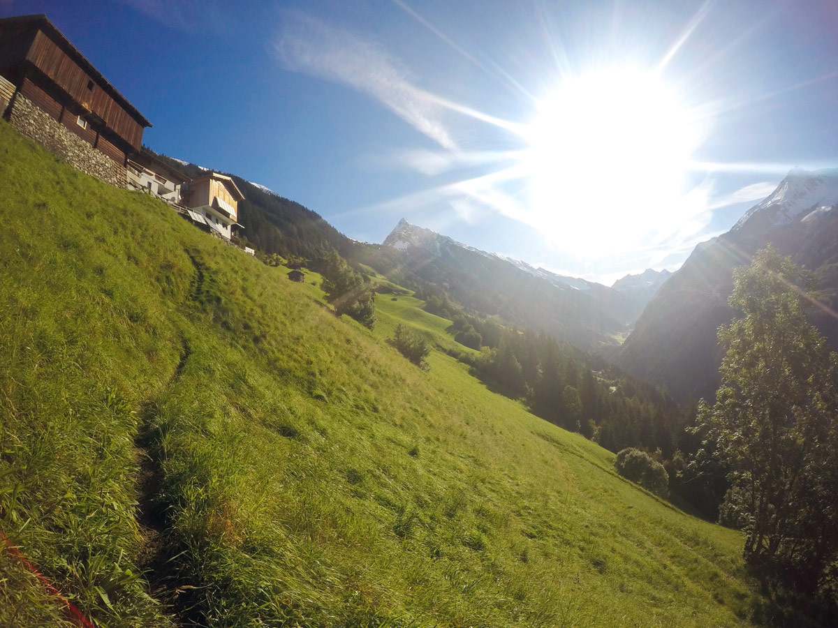 Passing the houses on Themenwanderung Bergmähderweg hike in Mayrhofen, Zillertal Valley, Austria