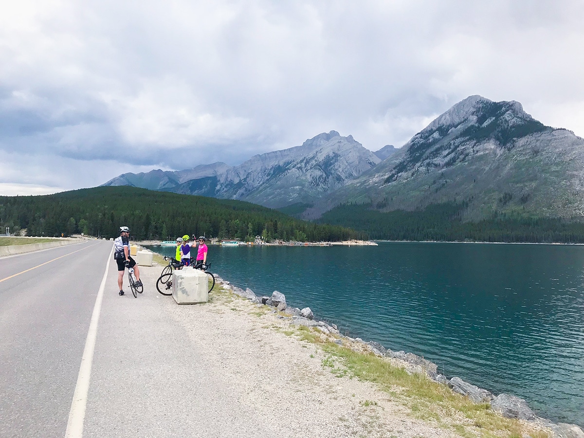 Crossing the causeway near the lake on Minnewanka Loop road biking route in Banff National Park