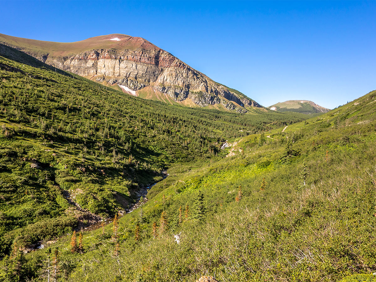 Crossing the creek on Loaf Mountain and Spionkop scramble in Castle Provincial Park, Alberta