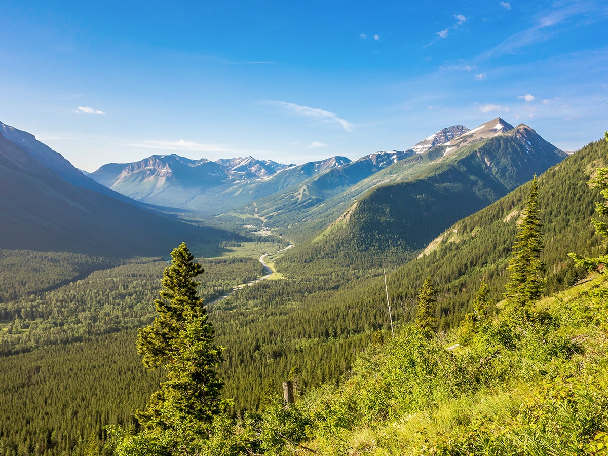 Views down the valley towards Castle Mountain Ski Resort on Syncline Mountain on Mount Coulthard scramble in Castle Provincial Park, Alberta